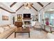 Comfortable living room features vaulted ceilings and a striking brick fireplace at 11660 Crabapple Rd, Roswell, GA 30075