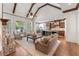 Spacious living room with vaulted ceiling, fireplace, and an open view to the kitchen at 11660 Crabapple Rd, Roswell, GA 30075