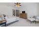 Bright main bedroom with tray ceilings, ceiling fan, and neutral decor at 11660 Crabapple Rd, Roswell, GA 30075