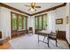 Sunlit office with wood trim, large windows, and a cozy ambiance at 11660 Crabapple Rd, Roswell, GA 30075