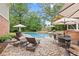 Backyard pool and brick patio with outdoor furniture, perfect for entertaining at 11660 Crabapple Rd, Roswell, GA 30075