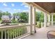 Spacious porch with views of the landscaped front yard and elegant home at 11660 Crabapple Rd, Roswell, GA 30075