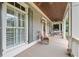 Inviting front porch with rocking chairs and view of the home's exterior at 11660 Crabapple Rd, Roswell, GA 30075