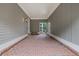 Covered portico area, featuring brick flooring and a gate leading to the backyard at 11660 Crabapple Rd, Roswell, GA 30075