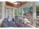 Inviting screened porch with comfortable seating and view of the pool and backyard at 11660 Crabapple Rd, Roswell, GA 30075
