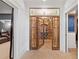 Unique wine cellar with brick walls and custom wooden shelving at 11660 Crabapple Rd, Roswell, GA 30075
