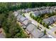 Overhead view of a residential neighborhood featuring well-kept homes, tree-lined streets, and backyard spaces at 155 Marlow Dr, Woodstock, GA 30188