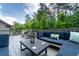 Back deck with outdoor seating, greenery, and space for entertaining guests outdoors at 155 Marlow Dr, Woodstock, GA 30188