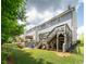 Spacious backyard featuring a patio with fire pit, lush lawn, and multilevel deck with gray siding at 155 Marlow Dr, Woodstock, GA 30188