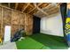 Unfinished basement with artificial turf and a golf simulator at 155 Marlow Dr, Woodstock, GA 30188