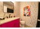 Bright bathroom showcasing vanity with pink cabinetry and playful wallpaper at 155 Marlow Dr, Woodstock, GA 30188