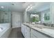 Elegant bathroom featuring dual sinks with granite countertop, glass shower, and white cabinets at 155 Marlow Dr, Woodstock, GA 30188