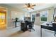 Bright bedroom featuring modern black desk, ceiling fan, and two windows with scenic backyard view at 155 Marlow Dr, Woodstock, GA 30188