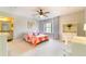 Sunlit bedroom includes a ceiling fan, soft carpet, and adjacent bathroom for added privacy at 155 Marlow Dr, Woodstock, GA 30188