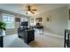 Bright bedroom featuring modern black desk, ceiling fan, and two windows overlooking the backyard at 155 Marlow Dr, Woodstock, GA 30188