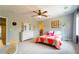Inviting bedroom with ceiling fan, soft carpet, and doorway to an en-suite bathroom at 155 Marlow Dr, Woodstock, GA 30188