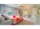 Comfortable bedroom is complete with natural light, plush carpet, and a ceiling fan at 155 Marlow Dr, Woodstock, GA 30188