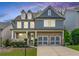 Charming two-story home with a brick facade, double garage, and a welcoming front porch at 155 Marlow Dr, Woodstock, GA 30188