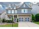 Charming two-story home with a brick-accented facade, two-car garage, and well-manicured landscaping at 155 Marlow Dr, Woodstock, GA 30188