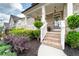 Inviting front exterior with brick accents, lush landscaping, and a charming front porch with white railings at 155 Marlow Dr, Woodstock, GA 30188