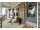 Charming front porch with brick, seating and a decorative wreath on a gray front door at 155 Marlow Dr, Woodstock, GA 30188