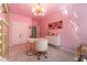 Pink home office featuring modern light fixture, stylish desk, and bright walls at 155 Marlow Dr, Woodstock, GA 30188