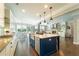 Open-concept kitchen features stainless steel appliances, a large island and hardwood floors at 155 Marlow Dr, Woodstock, GA 30188