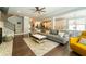 Open concept living room with hardwood floors, a cozy fireplace, and an adjacent staircase at 155 Marlow Dr, Woodstock, GA 30188