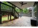 Covered patio with stamped concrete, stairs to deck, and a ceiling fan for outdoor comfort at 155 Marlow Dr, Woodstock, GA 30188