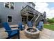 Inviting patio area with stone fire pit and comfortable blue Adirondack chairs at 155 Marlow Dr, Woodstock, GA 30188