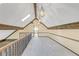 Attic space with skylights, wood beams, railings, and decorative pendant lighting at 1559 Norwood Dr, Lilburn, GA 30047