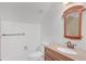 Bathroom featuring granite counters, a decorative mirror, and a toilet with a white seat at 1559 Norwood Dr, Lilburn, GA 30047