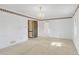 Bedroom features neutral walls, carpet, and trim, along with a wood paneled door at 1559 Norwood Dr, Lilburn, GA 30047