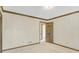 Bedroom featuring neutral walls, carpet, and trim, along with a wood paneled door at 1559 Norwood Dr, Lilburn, GA 30047