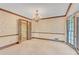 Formal dining room with custom trim, chair rail, large windows, and neutral carpeting at 1559 Norwood Dr, Lilburn, GA 30047