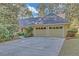 Exterior elevation of home featuring attached garage and private driveway at 1559 Norwood Dr, Lilburn, GA 30047