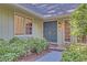 Charming front entryway featuring a blue front door, sidelight windows, and manicured landscaping at 1559 Norwood Dr, Lilburn, GA 30047