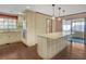 Bright kitchen with an island, pendant lights, stainless steel appliances, and wood floors at 1559 Norwood Dr, Lilburn, GA 30047