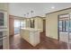 Bright kitchen with an island, stainless steel appliances, a breakfast nook, and hardwood floors at 1559 Norwood Dr, Lilburn, GA 30047