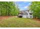 Expansive backyard featuring a deck, lush lawn, and tree line, offering outdoor space at 529 Wintergreen Way, Canton, GA 30115