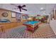 Finished basement features a pool table, bar area with neon signs, and a unique ceiling fan at 529 Wintergreen Way, Canton, GA 30115