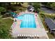 Large community pool with a slide, surrounded by comfortable seating and lush landscaping at 529 Wintergreen Way, Canton, GA 30115