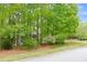 Exterior view of a home surrounded by lush trees and greenery at 529 Wintergreen Way, Canton, GA 30115