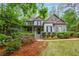 Charming two-story home featuring a covered front porch and well-manicured landscaping at 529 Wintergreen Way, Canton, GA 30115