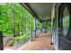 Inviting front porch with ample seating and a view of the surrounding greenery at 529 Wintergreen Way, Canton, GA 30115