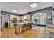 Eat-in kitchen and breakfast nook with stainless steel appliances, island with seating, and wooden cabinetry at 529 Wintergreen Way, Canton, GA 30115