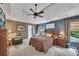 Comfortable main bedroom featuring a ceiling fan, tray ceiling, and en-suite bathroom at 529 Wintergreen Way, Canton, GA 30115