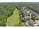 An aerial view of a golf course community with large manicured lawns and mature trees at 146 Cedar Woods Trl, Canton, GA 30114