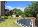 This sprawling backyard features an in-ground trampoline, fire pit, spiral staircase, and lush landscaping at 146 Cedar Woods Trl, Canton, GA 30114