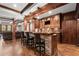 Charming bar area with brick accents, custom cabinetry, and elegant lighting fixtures at 146 Cedar Woods Trl, Canton, GA 30114